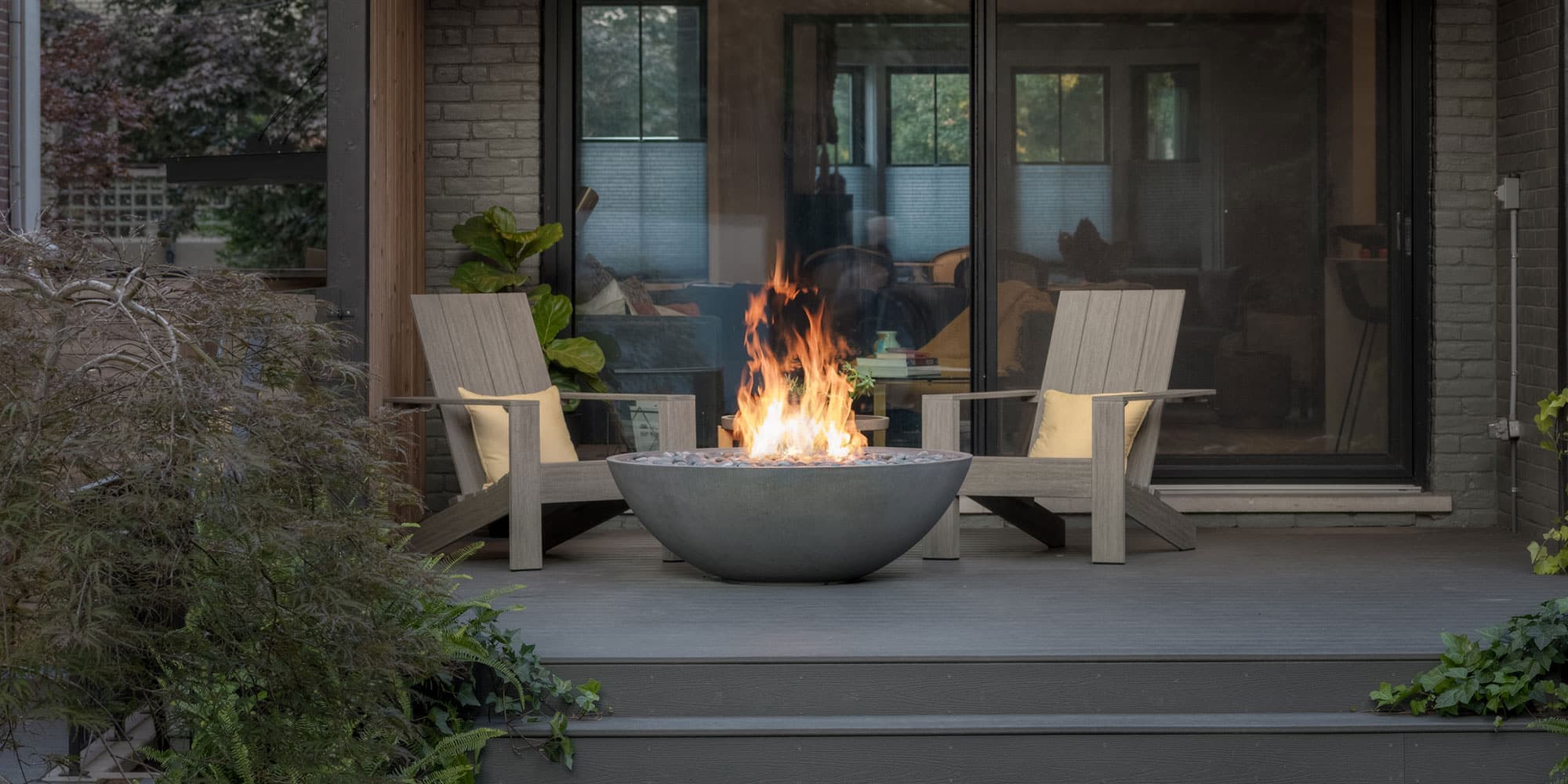 48-inch rectangular fire pit centered on a paver patio at dusk