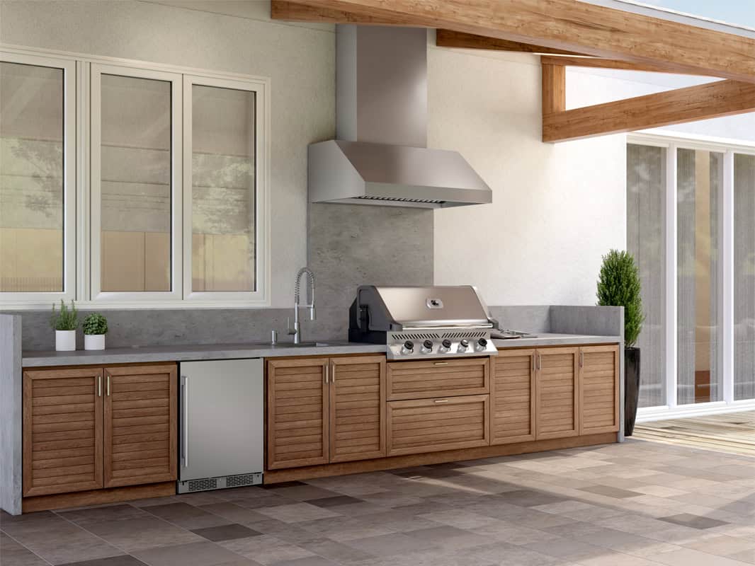 Zephyr Cypress 36-inch outdoor canopy vent hood installed above a built-in gas grill in a wood-cabinet outdoor kitchen under a timber-beam covered patio, with the telescopic duct cover reaching into the pitched ceiling.
